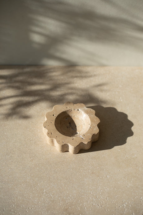 The Mini Sun Scoop Travertine by Anastasio Home, handcrafted from a single piece of solid marble stone. This decorative tray features a unique design and natural stone variations, perfect for your coffee table or vanity.