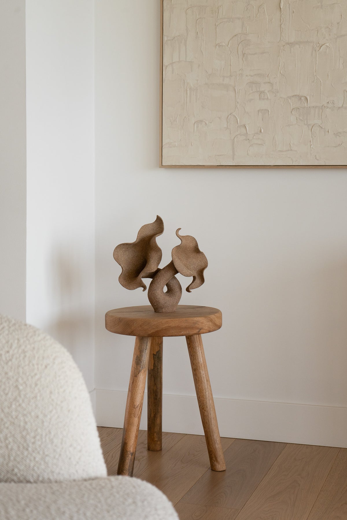 A striking piece of ceramic art, featuring a soft, seductive shell contrasted with raw, coarse textures. The vessel, crafted from textured matte grog stoneware with a brown exterior and glazed interior, evokes a dramatic allure and delicate inner essence. 