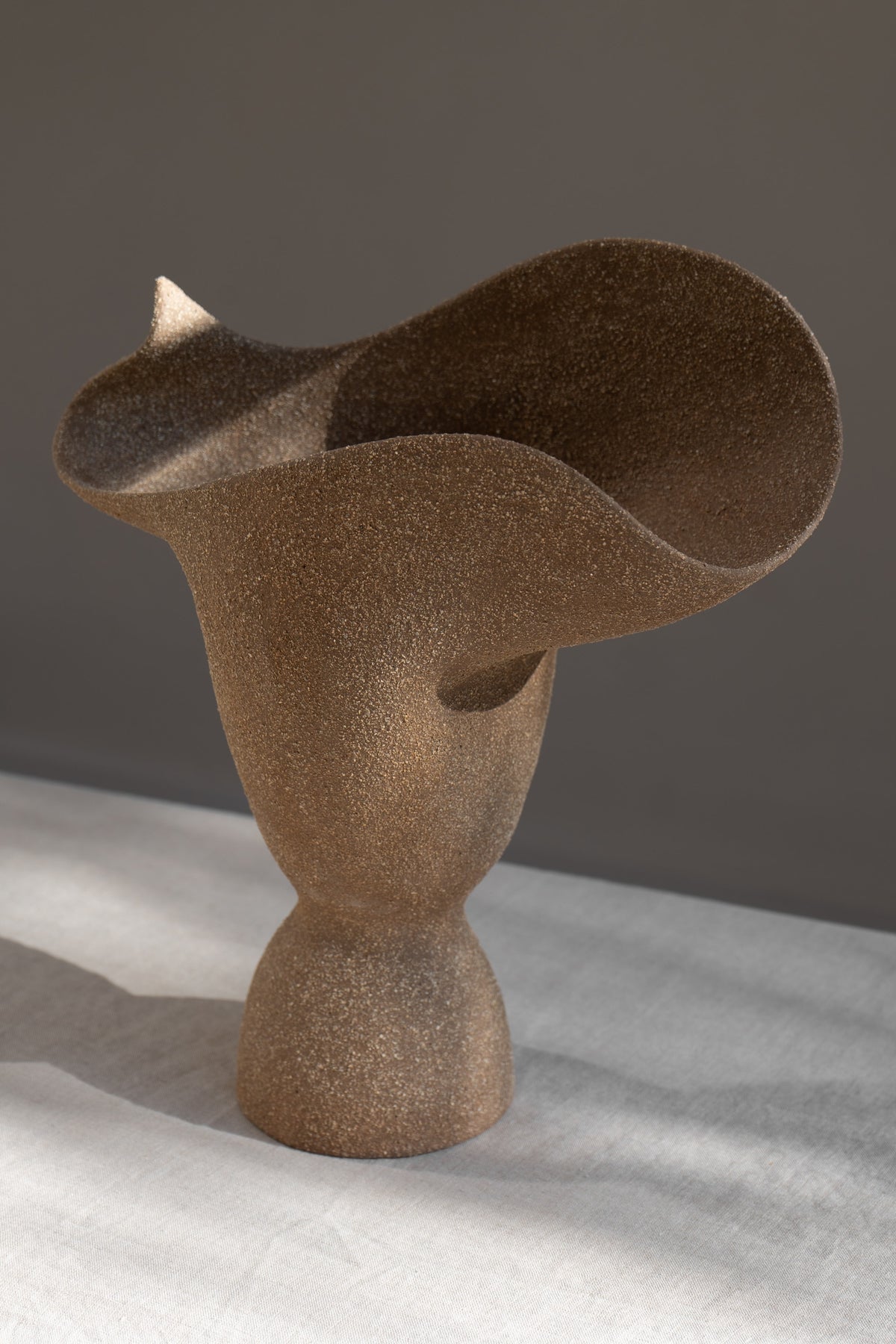 The Adorned Sculptural Vessel is a water-tight stoneware vase that can hold your favorite seasonal florals and branches.