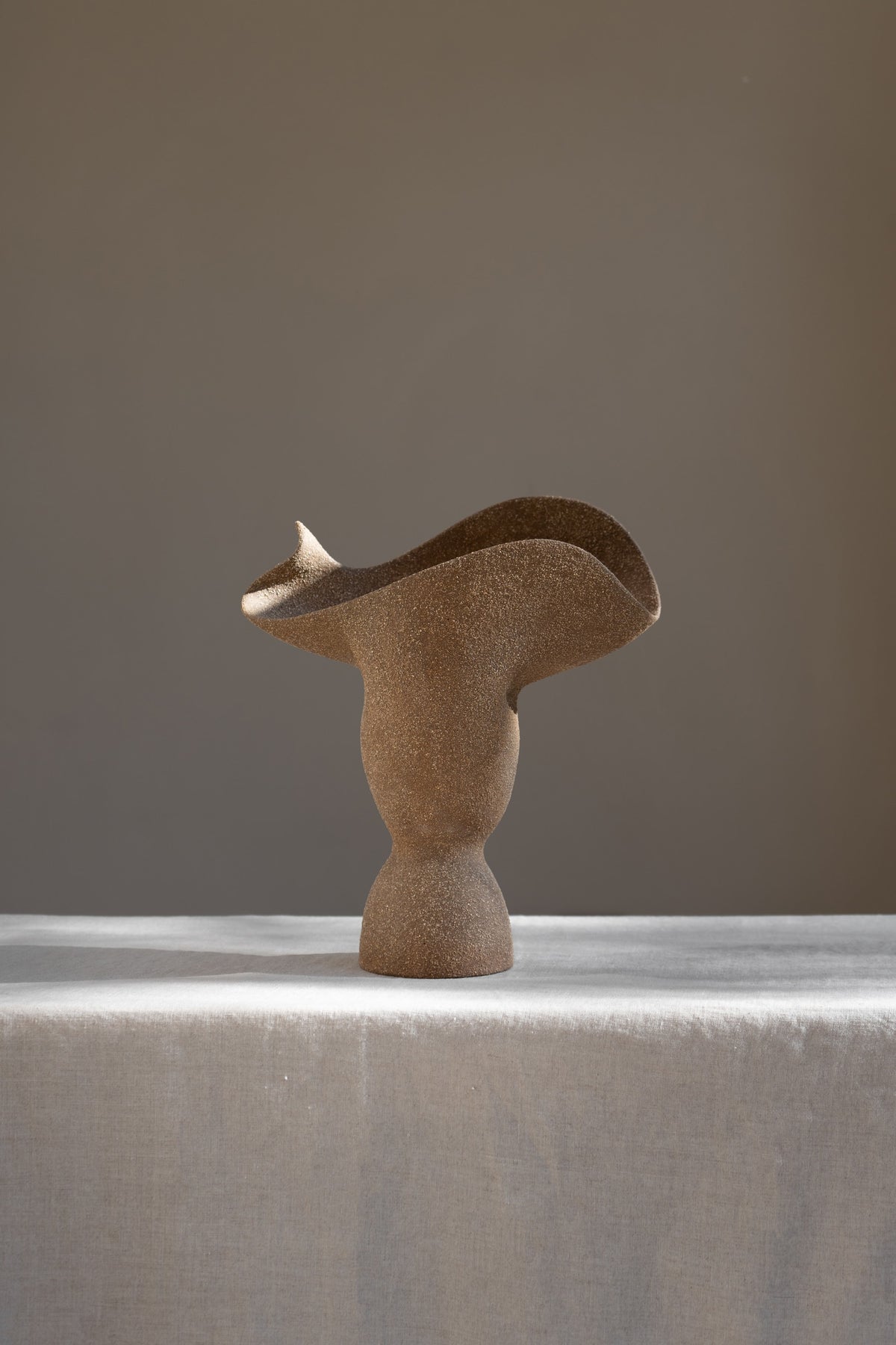 The Adorned Sculptural Vessel is a water-tight stoneware vase that can hold your favorite seasonal florals and branches.