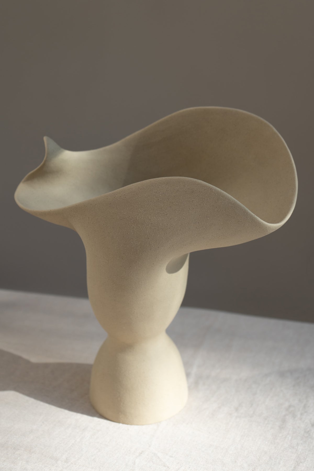 The Adorned Sculptural Vessel is a water-tight stoneware vase that can hold your favorite seasonal florals and branches.