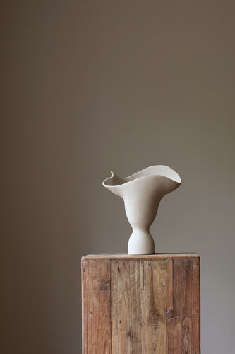 The Adorned Sculptural Vessel is a water-tight stoneware vase that can hold your favorite seasonal florals and branches.