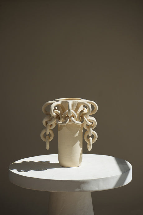 The Agora Chained Vessel is a sculptural masterpiece featuring interlocking chains inspired by Roman pottery and Italian culture. 