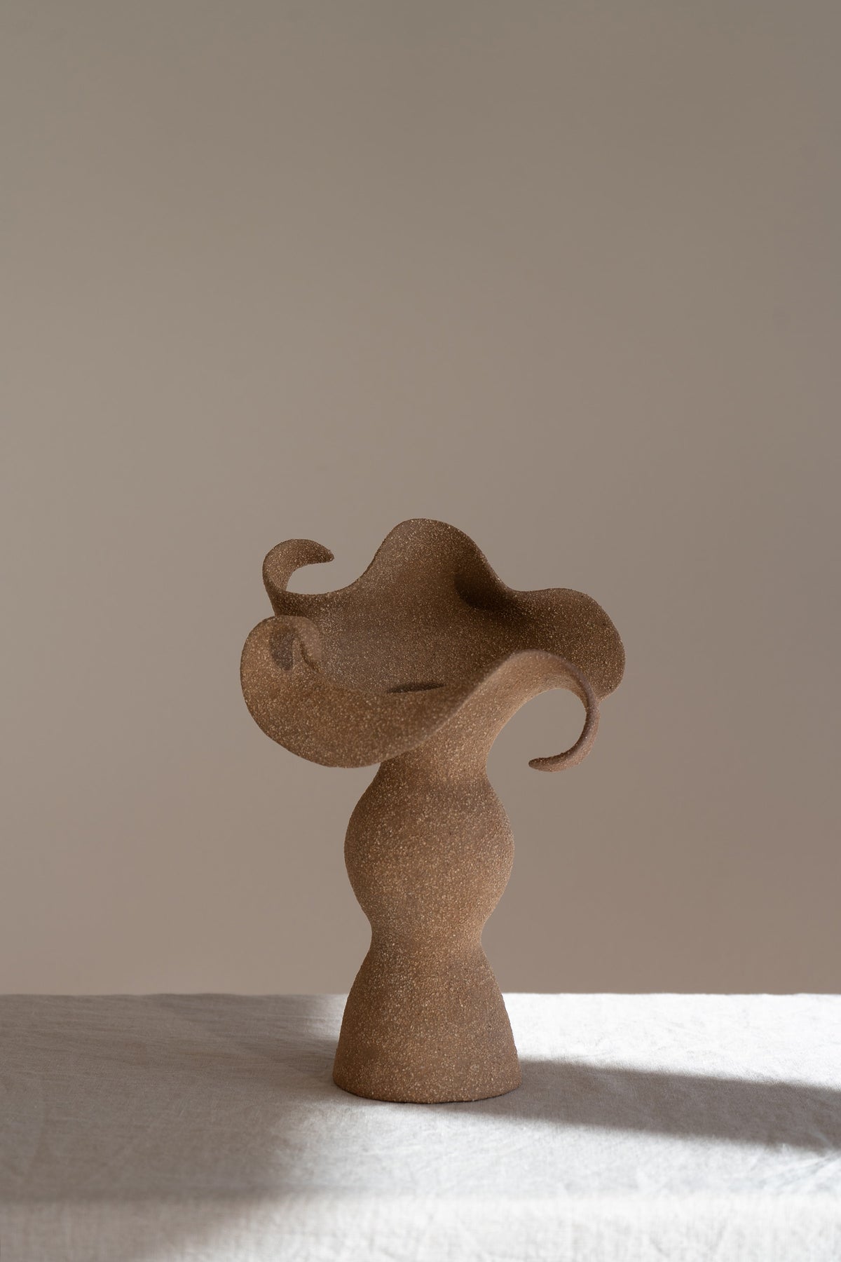 A beautifully crafted stoneware vase with curvaceous, organic outlines and soft brutalist forms. 
