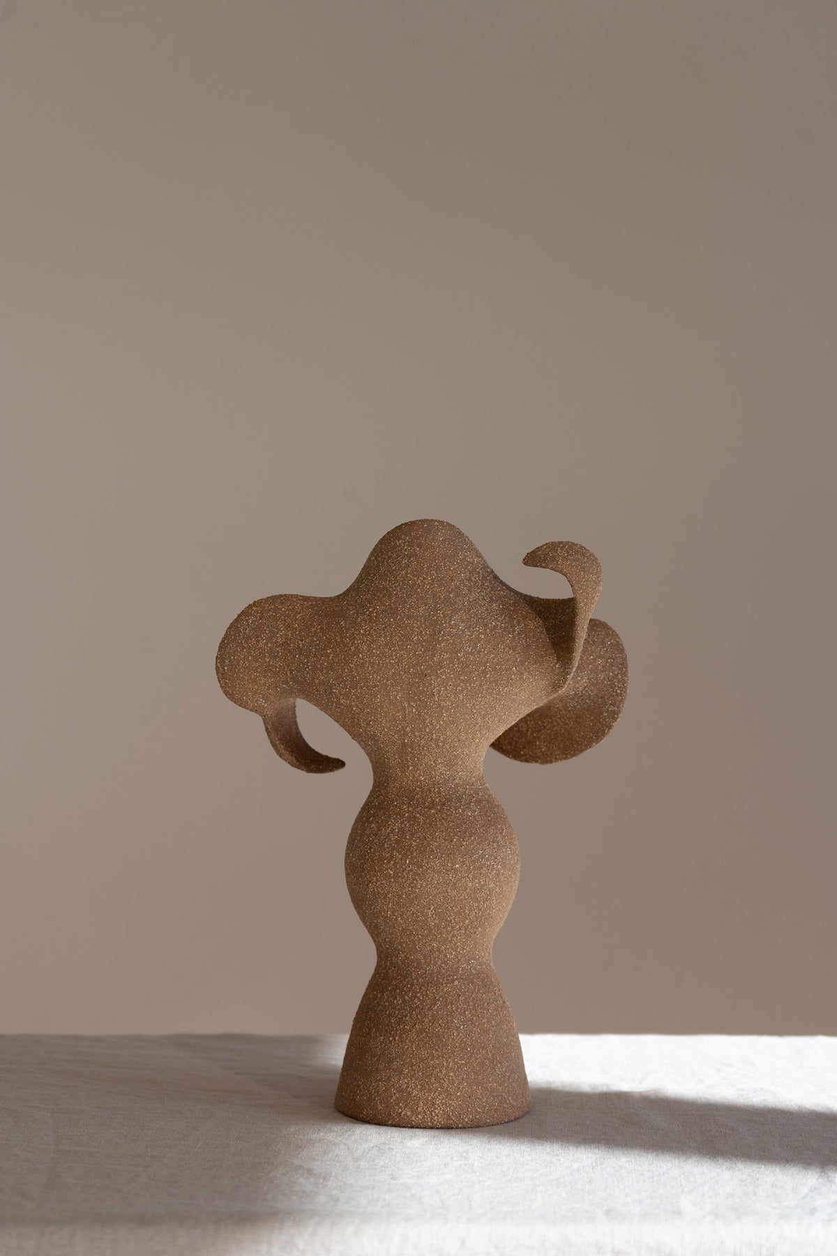 A beautifully crafted stoneware vase with curvaceous, organic outlines and soft brutalist forms. 