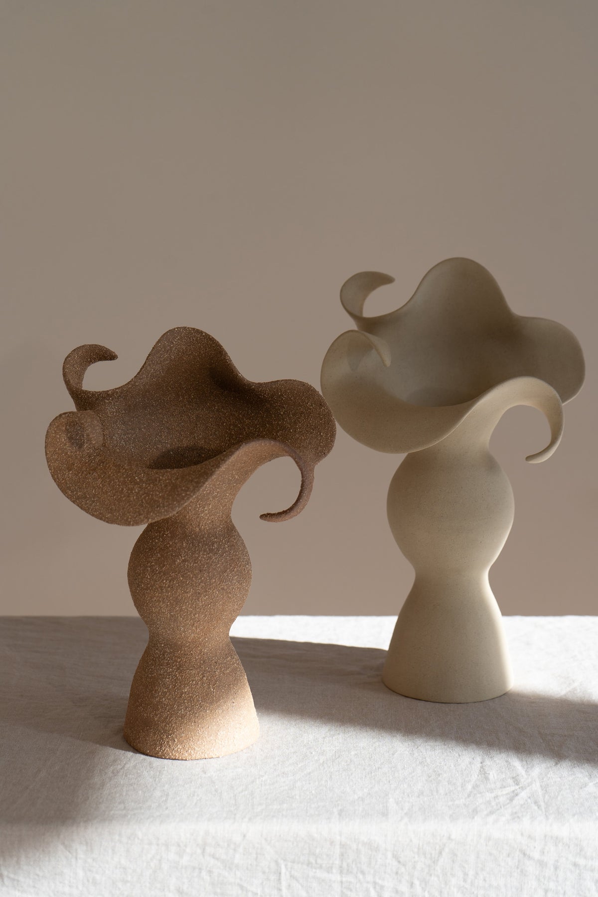 A beautiful stoneware vase, the Amorous Sculptural Vessel is a home decor art piece that mixes soft brutalism with natural grooves and curves.