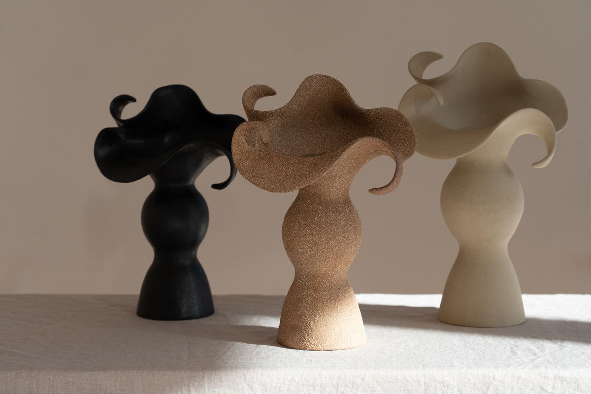 A beautifully crafted stoneware vase with curvaceous, organic outlines and soft brutalist forms. 