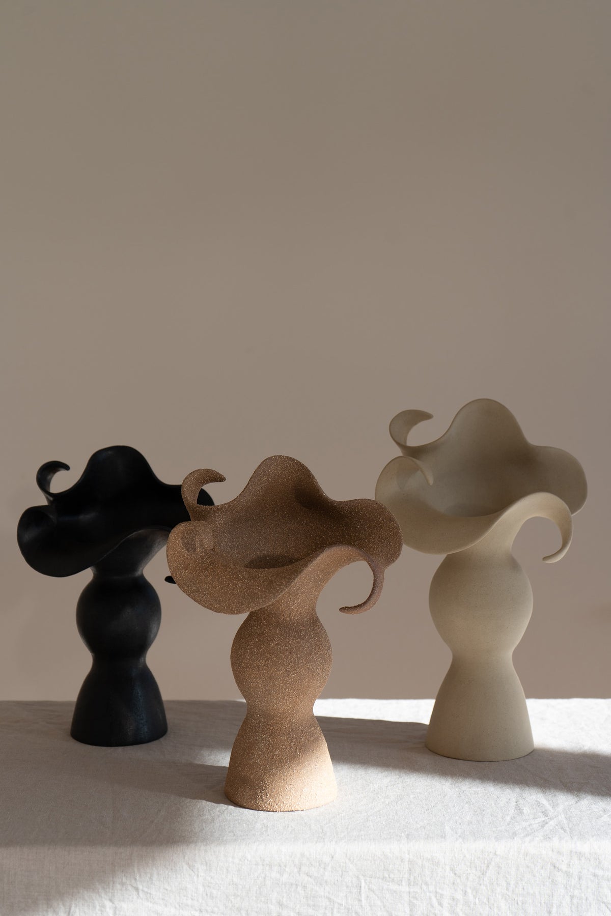 A beautiful stoneware vase, the Amorous Sculptural Vessel is a home decor art piece that mixes soft brutalism with natural grooves and curves.