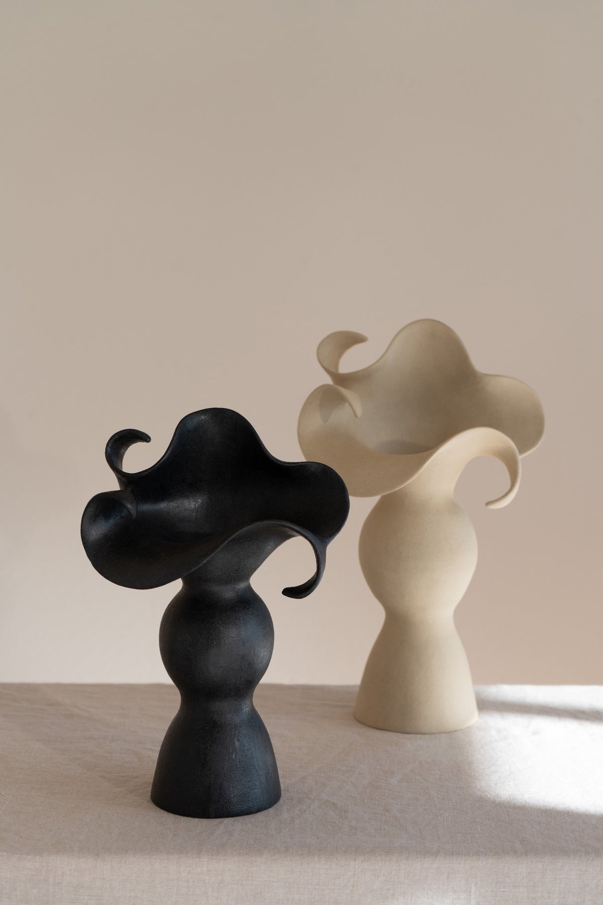 A beautiful stoneware vase, the Amorous Sculptural Vessel is a home decor art piece that mixes soft brutalism with natural grooves and curves.