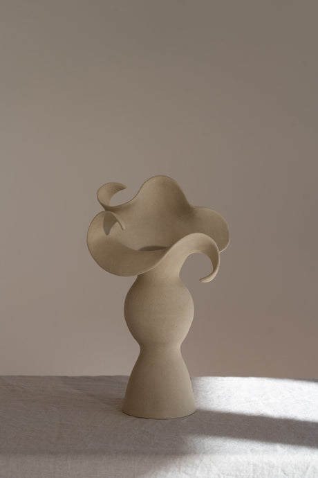 A beautiful stoneware vase, the Amorous Sculptural Vessel is a home decor art piece that mixes soft brutalism with natural grooves and curves.