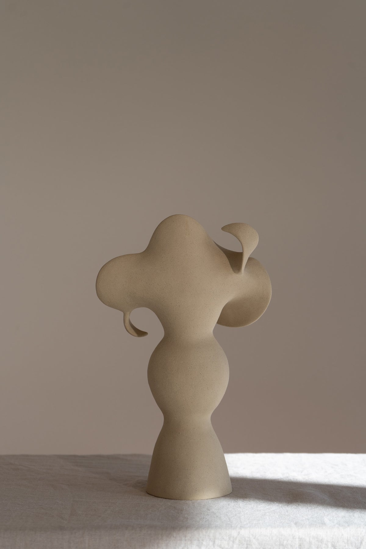 A beautiful stoneware vase, the Amorous Sculptural Vessel is a home decor art piece that mixes soft brutalism with natural grooves and curves.