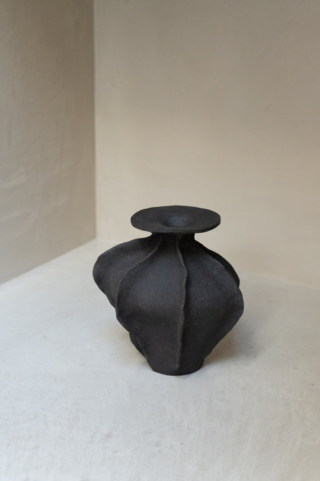 Crafted in textured matte black with a unique design inspired by the hills and seas of Baja California, this water-tight vessel doubles as both art and functional vase. Ideal for florals or branches.