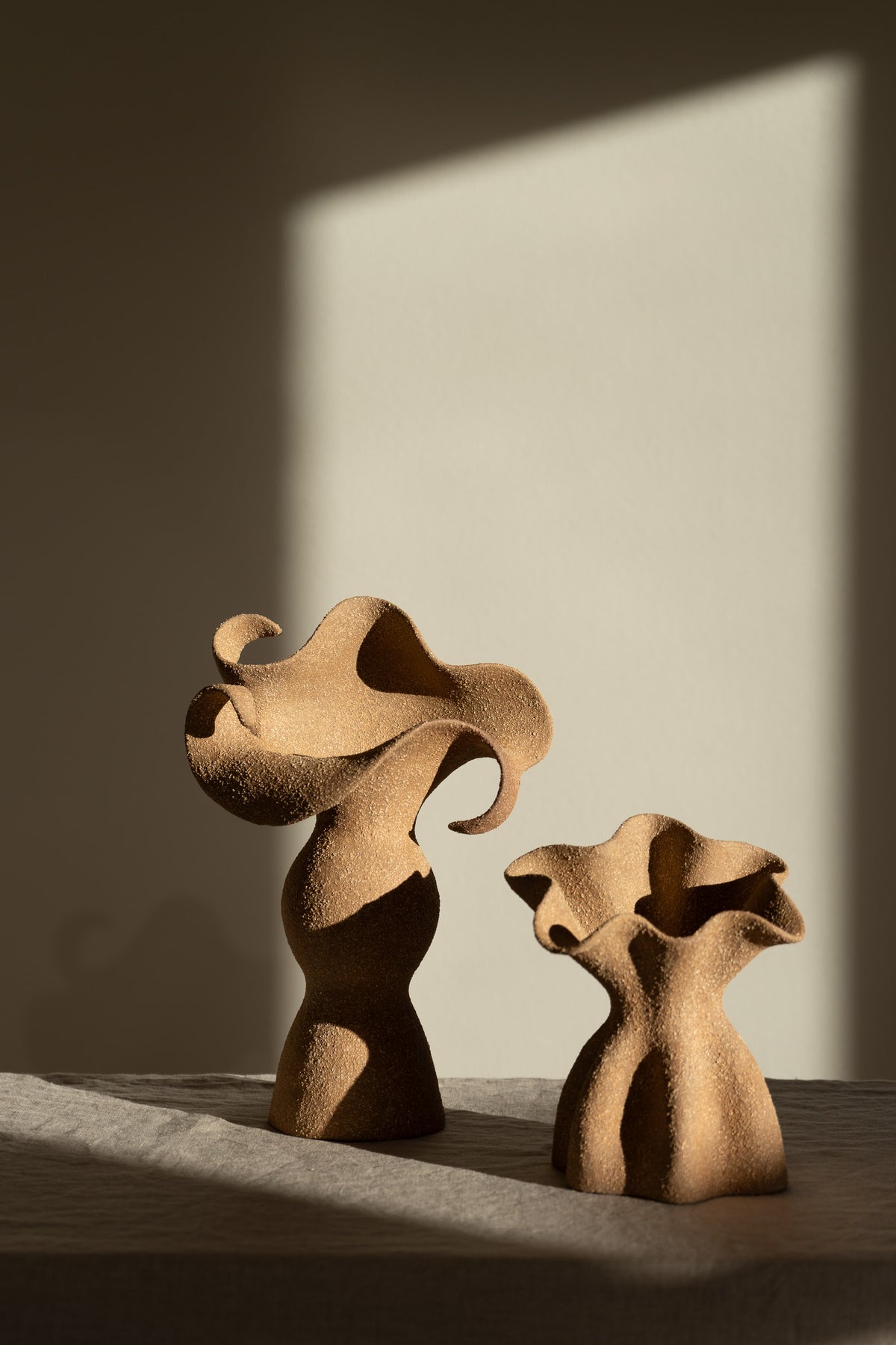 A beautifully crafted stoneware vase with curvaceous, organic outlines and soft brutalist forms. 