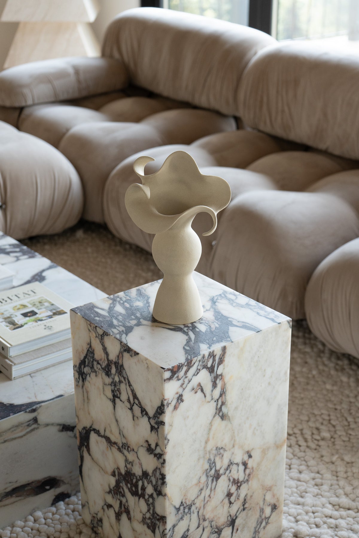 A beautiful stoneware vase, the Amorous Sculptural Vessel is a home decor art piece that mixes soft brutalism with natural grooves and curves.