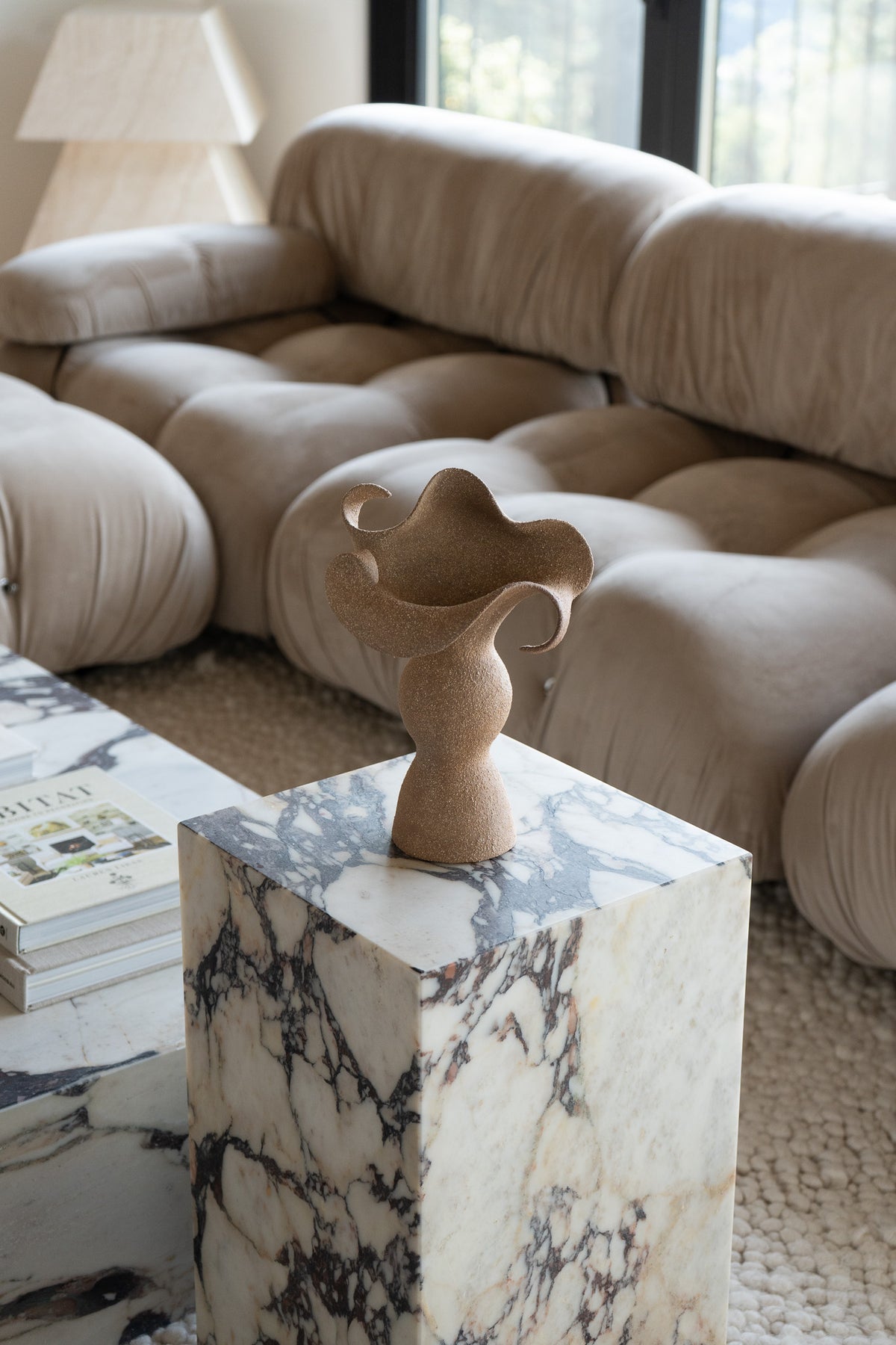 A beautifully crafted stoneware vase with curvaceous, organic outlines and soft brutalist forms. 