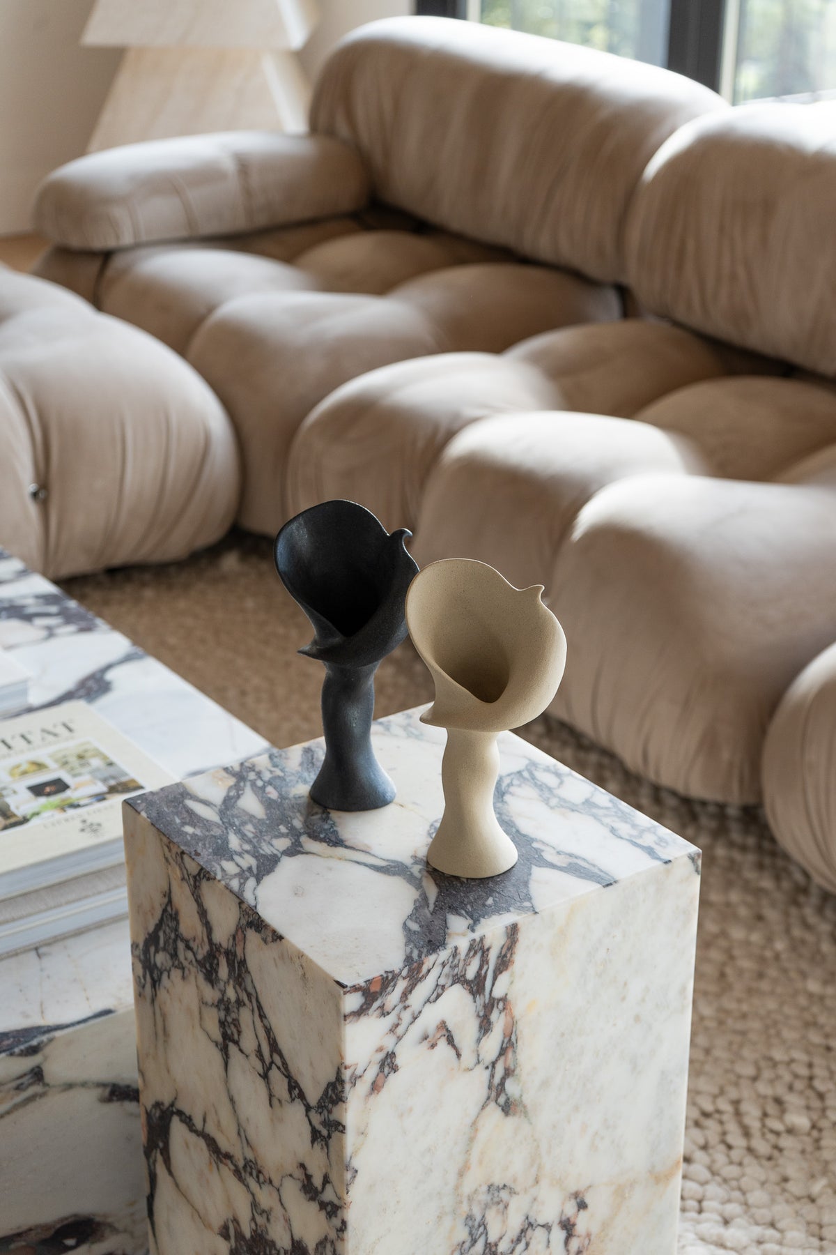A matte taupe ceramic vase inspired by the Calla Lily, combining bold stoneware with soft floral curves. 