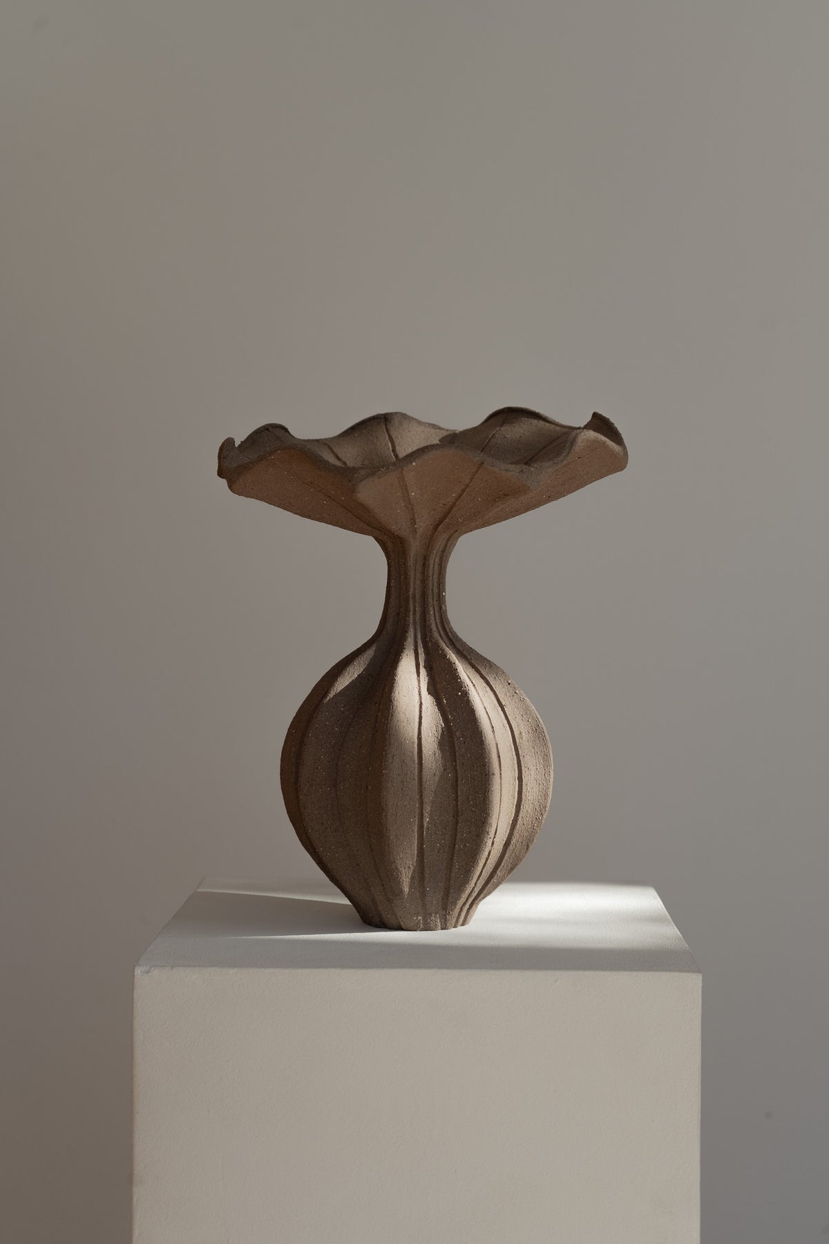 The Peplum Vessel, with its unique silhouette and contrasting form, creates an interesting focal point in your space.