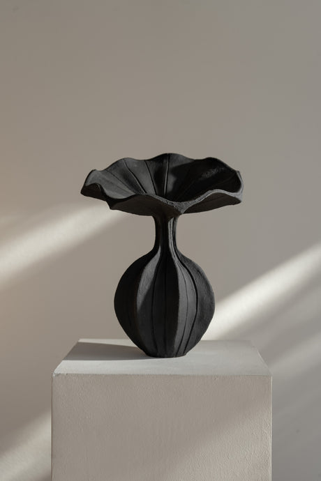The Peplum Vessel, with its unique silhouette and contrasting form, creates an interesting focal point in your space. 