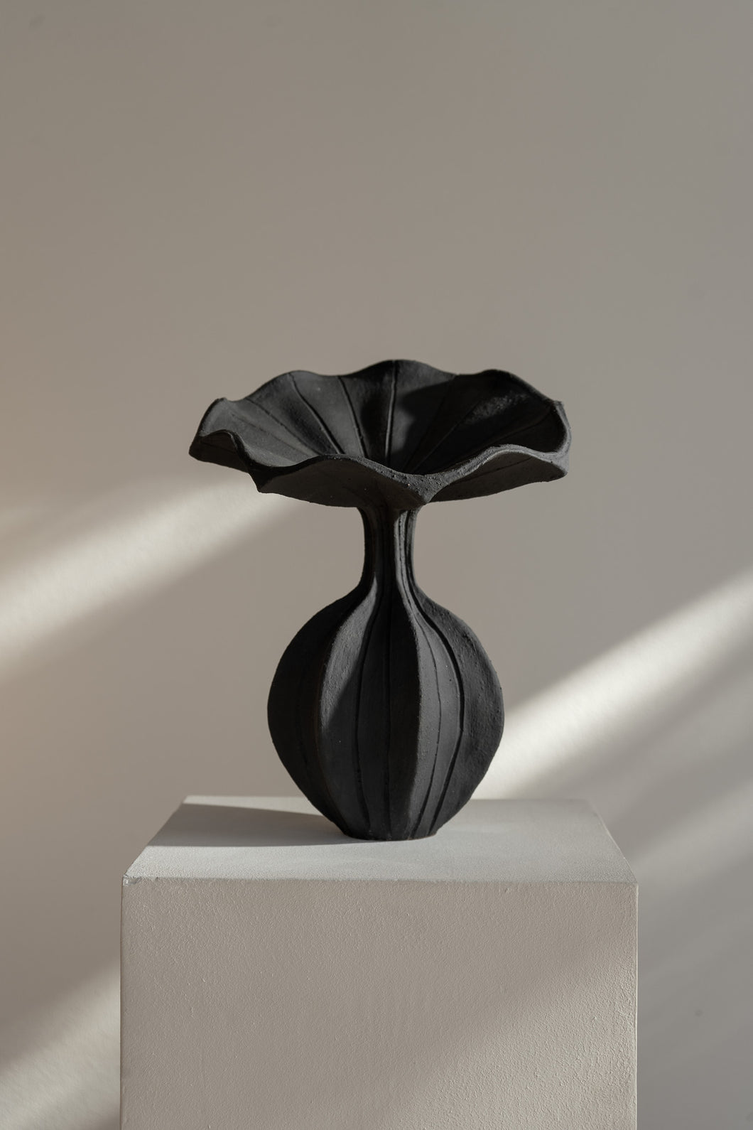 The Peplum Vessel, with its unique silhouette and contrasting form, creates an interesting focal point in your space. 