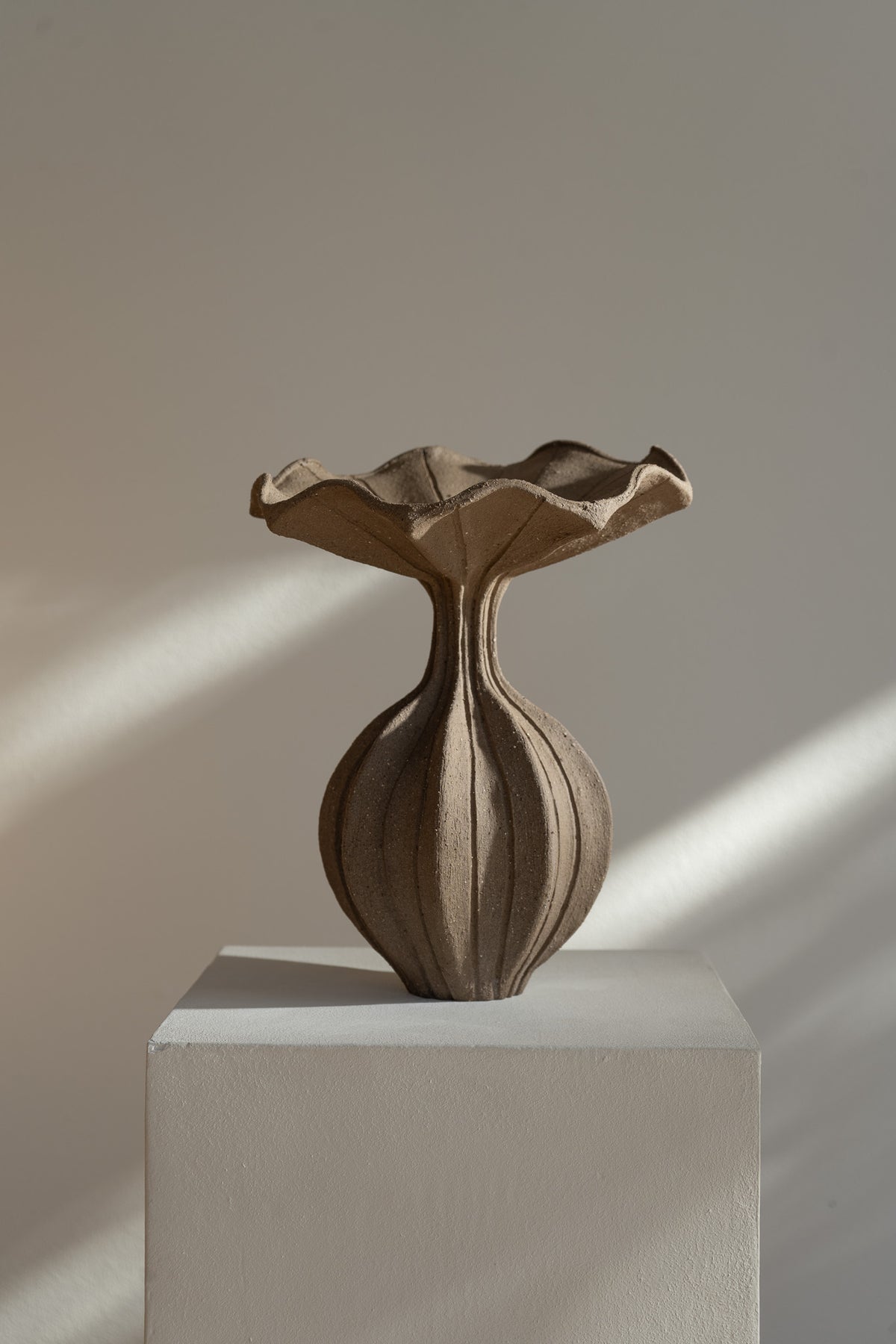 The Peplum Vessel, with its unique silhouette and contrasting form, creates an interesting focal point in your space.