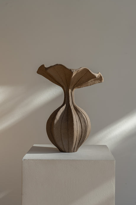 The Peplum Vessel, with its unique silhouette and contrasting form, creates an interesting focal point in your space.