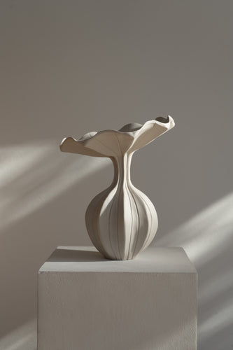 The Peplum Vessel, with its unique silhouette and contrasting form, creates an interesting focal point in your space.