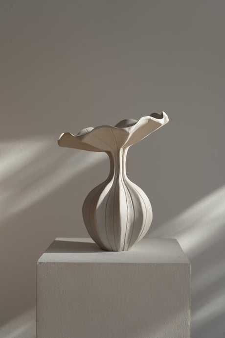 The Peplum Vessel, with its unique silhouette and contrasting form, creates an interesting focal point in your space.