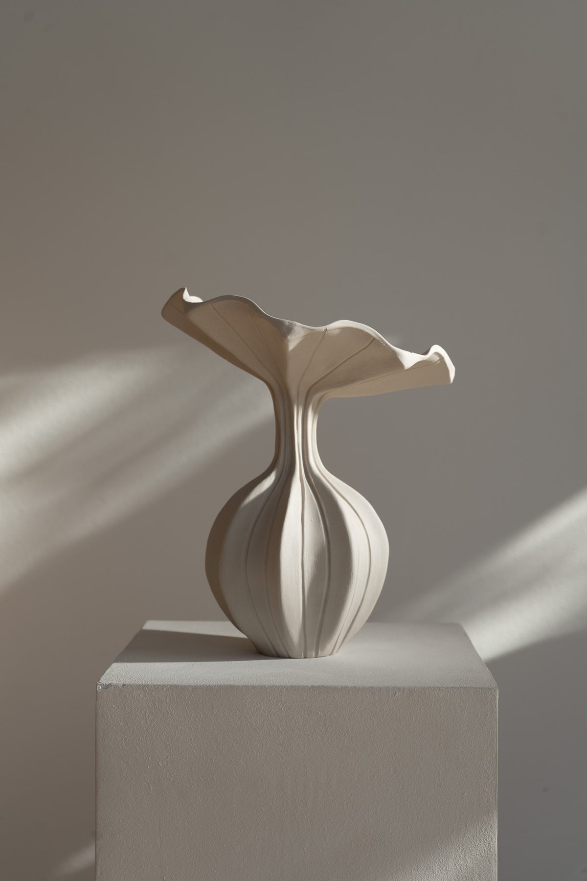 The Peplum Vessel, with its unique silhouette and contrasting form, creates an interesting focal point in your space.
