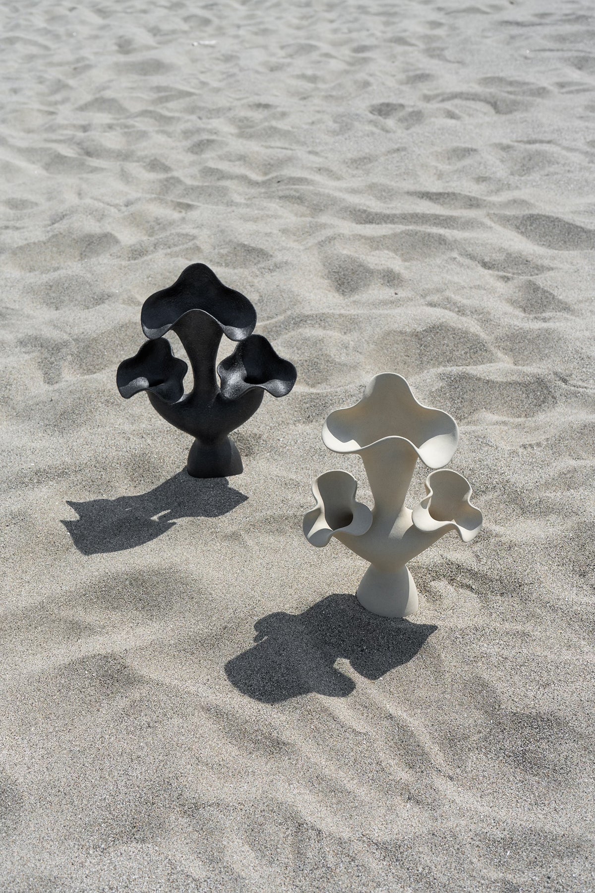 The Lilies Sculptural Vessel features a beautiful silhouette similar to its namesake flower, with soft petal-like curves blossoming from the vase openings.