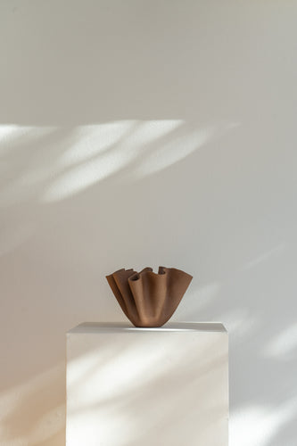 This hand-crafted ceramic bowl blends organic form with sculptural elegance. The Espresso Ceramic Ruffle Bowl rises from a stable base into a flowing, ruffled rim. Perfect as a centerpiece or stylish accent—functional, artful, and unique.