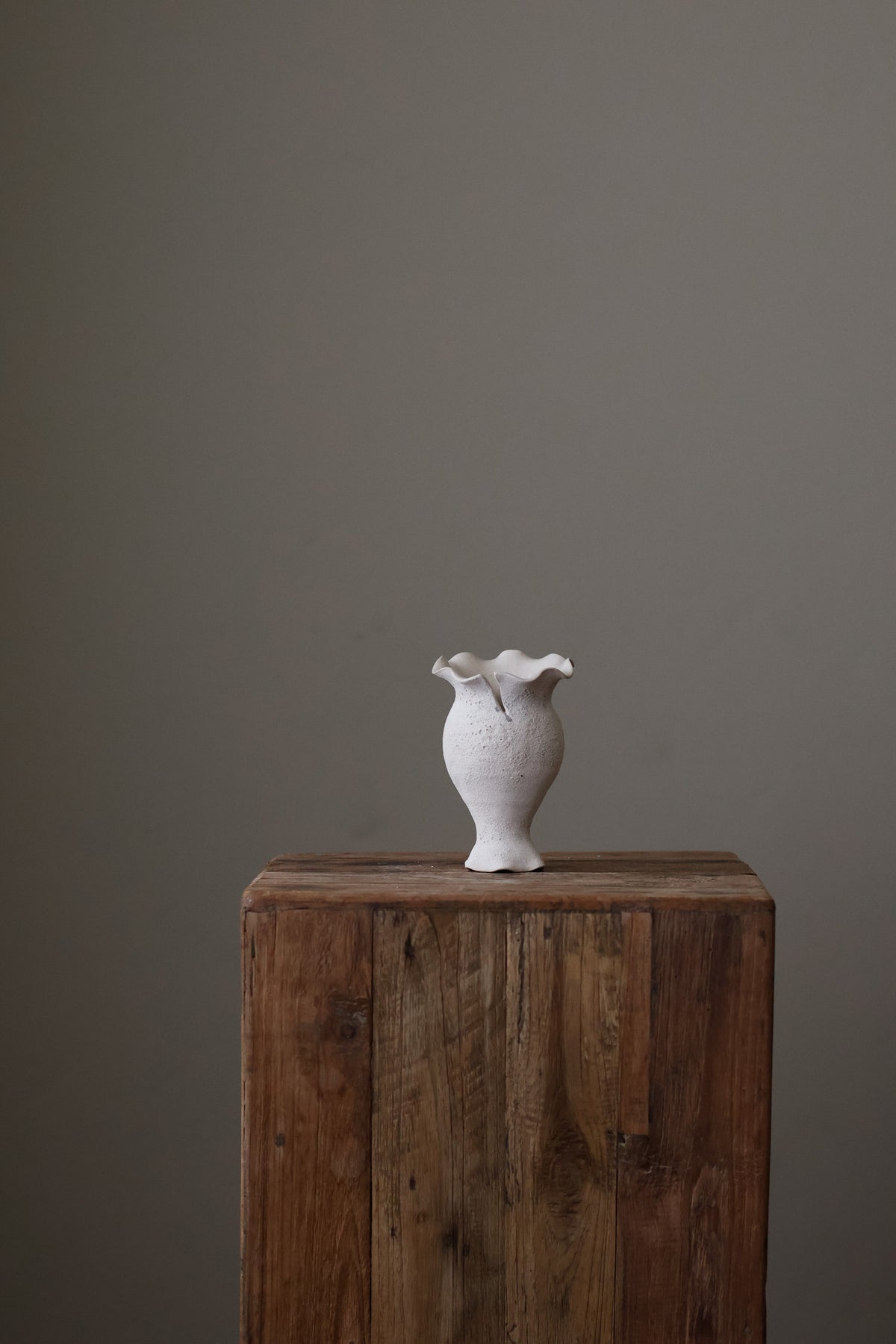 Blossoming Bud Vase in White Lava Glaze, Inspired by the tender rise of twin tulips from a single stem, this hand-built vase features two ruffled openings atop a shared base, each echoing the graceful unfurl of a bloom. 