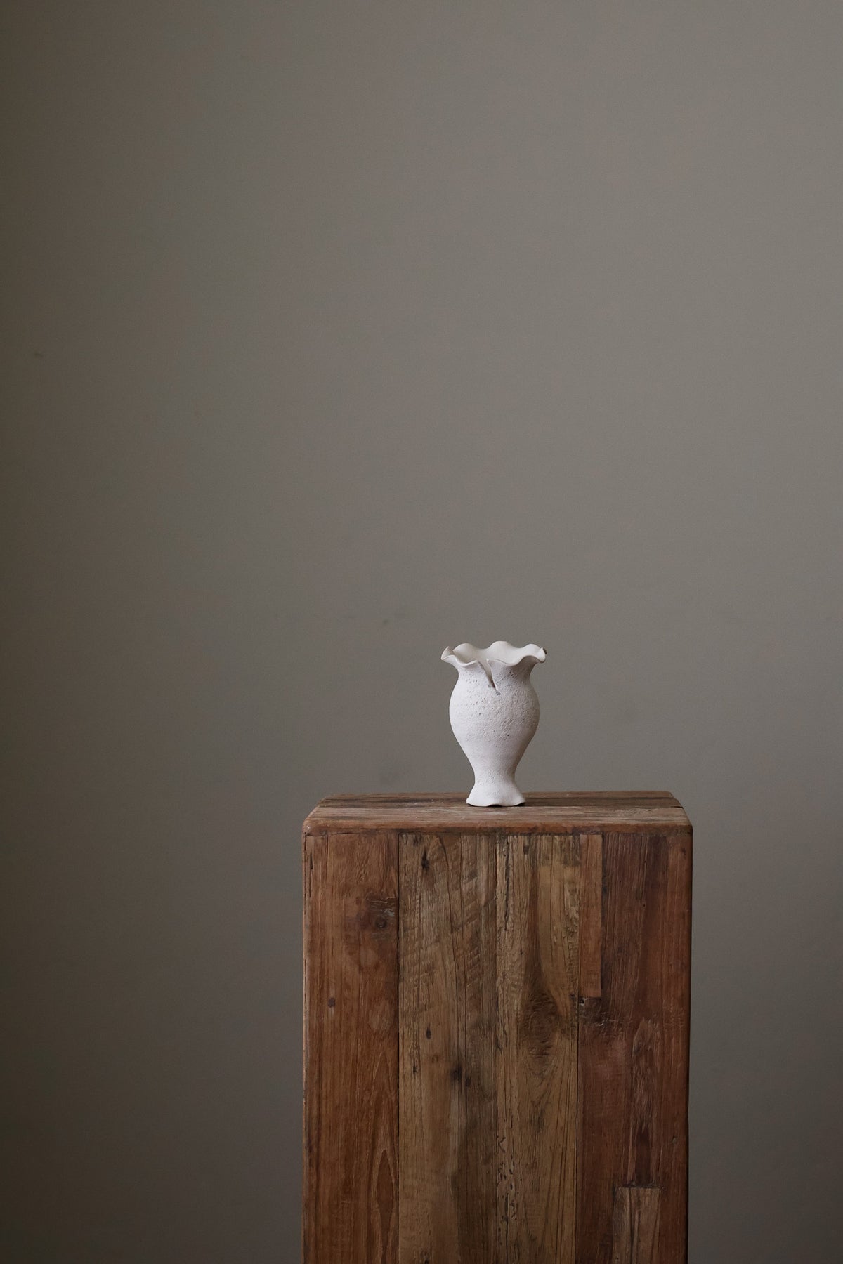 Blossoming Bud Vase in White Lava Glaze, Inspired by the tender rise of twin tulips from a single stem, this hand-built vase features two ruffled openings atop a shared base, each echoing the graceful unfurl of a bloom. 