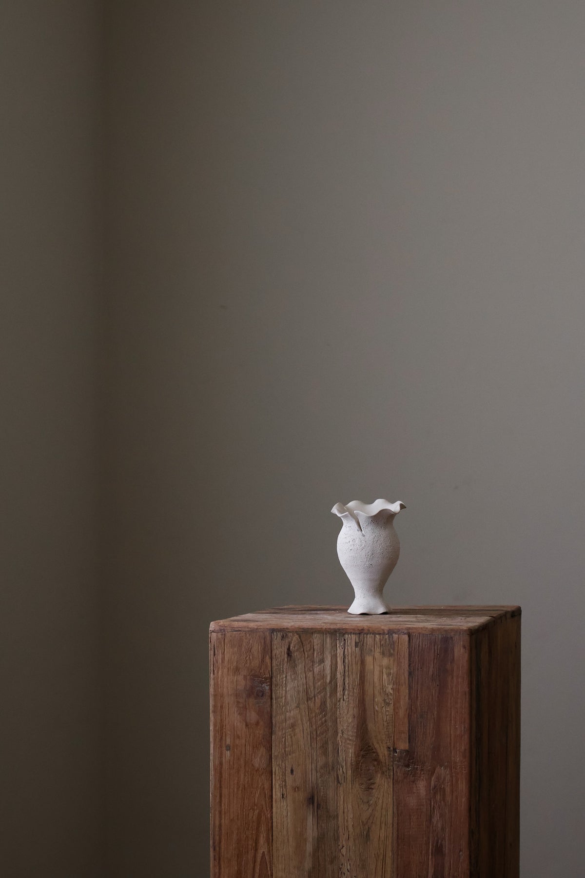 Blossoming Bud Vase in White Lava Glaze, Inspired by the tender rise of twin tulips from a single stem, this hand-built vase features two ruffled openings atop a shared base, each echoing the graceful unfurl of a bloom. 