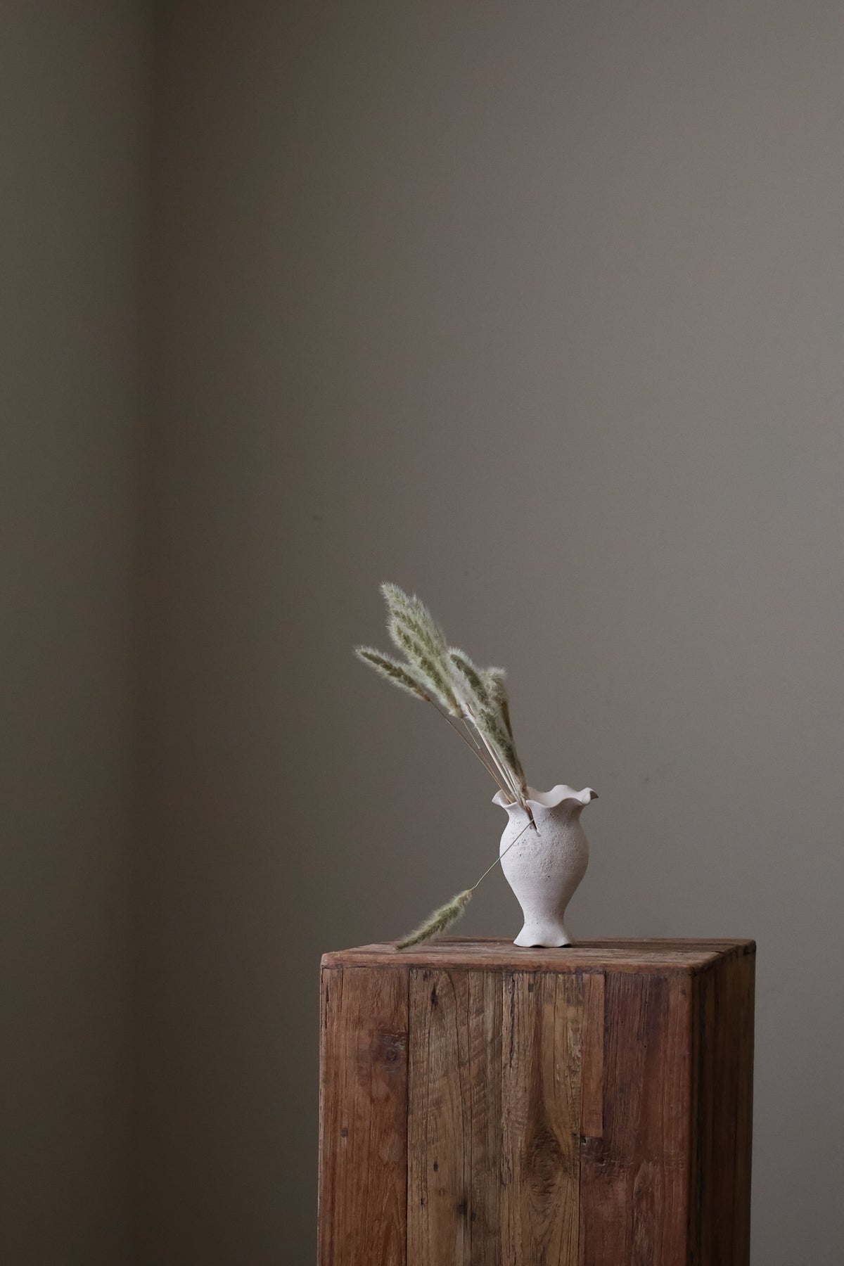 Blossoming Bud Vase in White Lava Glaze, Inspired by the tender rise of twin tulips from a single stem, this hand-built vase features two ruffled openings atop a shared base, each echoing the graceful unfurl of a bloom. 