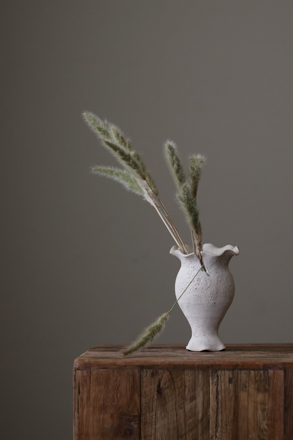 Blossoming Bud Vase in White Lava Glaze, Inspired by the tender rise of twin tulips from a single stem, this hand-built vase features two ruffled openings atop a shared base, each echoing the graceful unfurl of a bloom. 