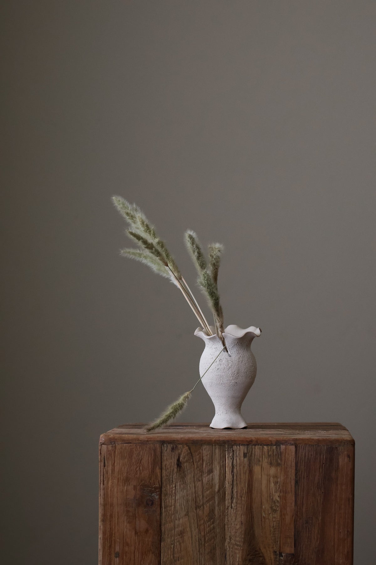 Blossoming Bud Vase in White Lava Glaze, Inspired by the tender rise of twin tulips from a single stem, this hand-built vase features two ruffled openings atop a shared base, each echoing the graceful unfurl of a bloom. 