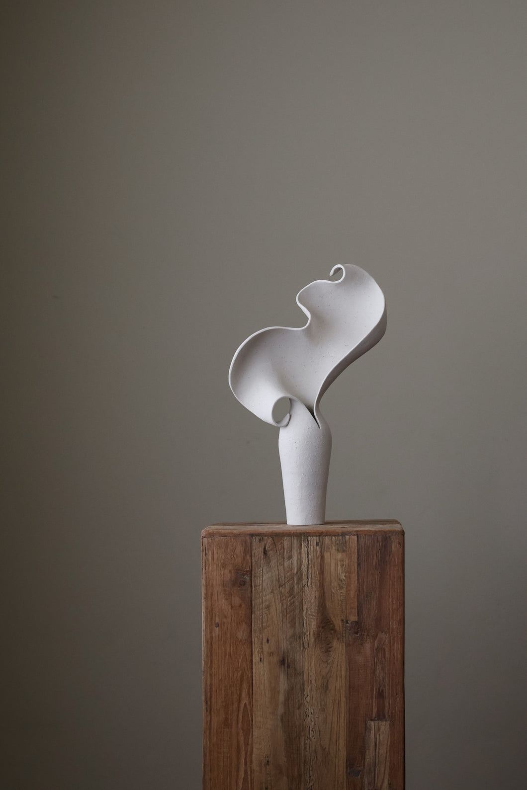 Scala Sculptural Vessel, Contemporary ceramic art vase with elegant abstract form and fluid sculptural curves, featuring a matte white speckled finish