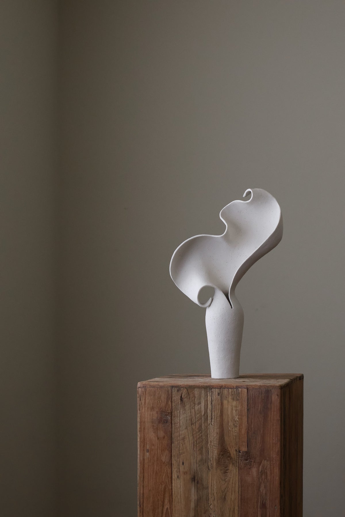 Scala Sculptural Vessel, Contemporary ceramic art vase with elegant abstract form and fluid sculptural curves, featuring a matte white speckled finish