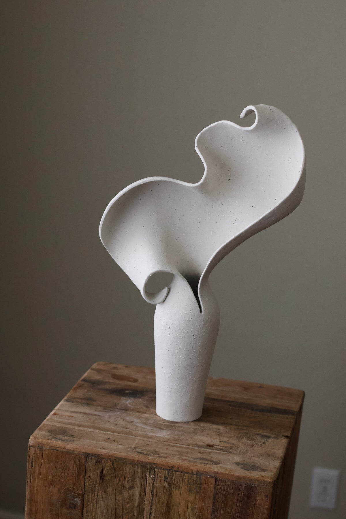 Scala Sculptural Vessel, Contemporary ceramic art vase with elegant abstract form and fluid sculptural curves, featuring a matte white speckled finish