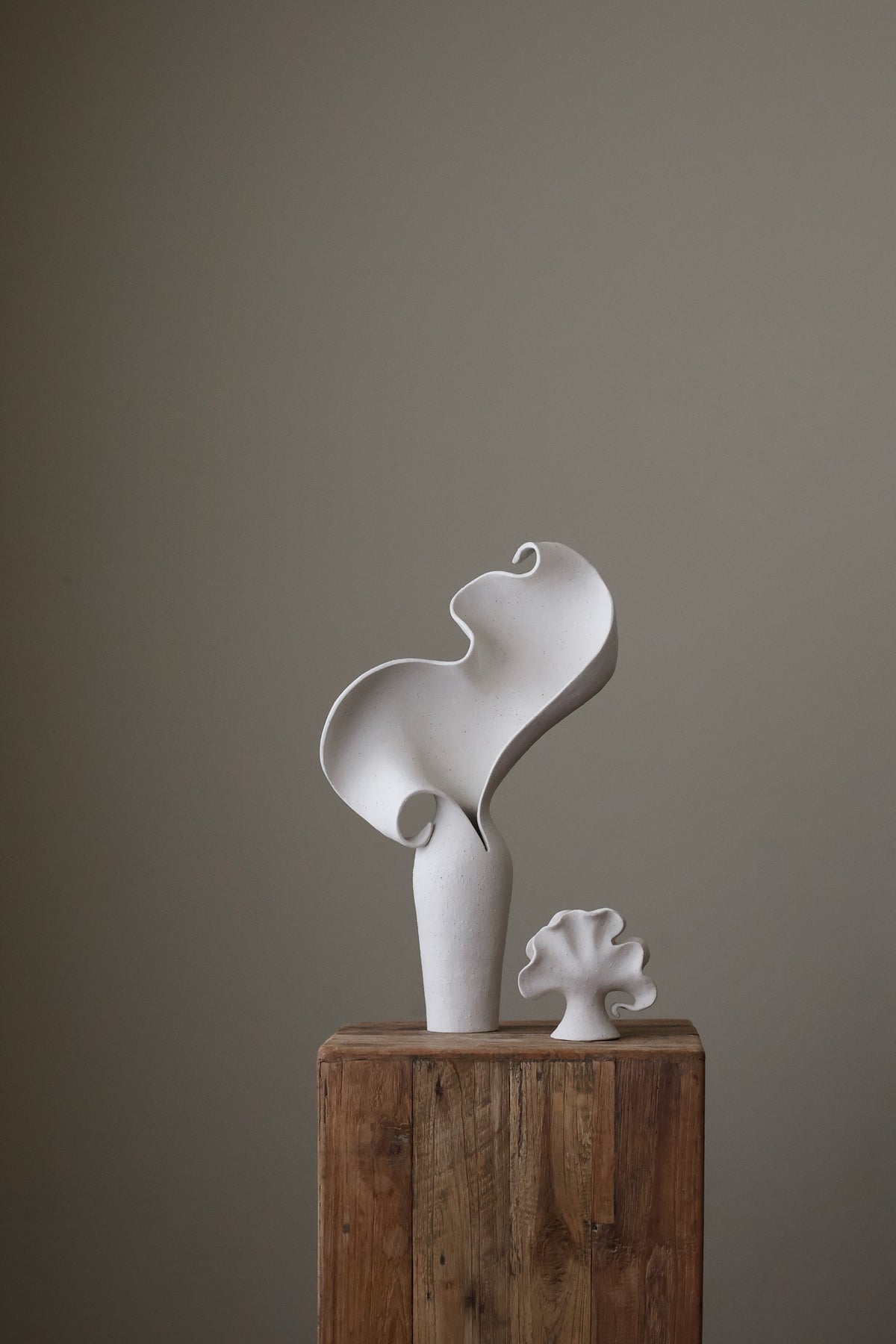 Scala Sculptural Vessel, Contemporary ceramic art vase with elegant abstract form and fluid sculptural curves, featuring a matte white speckled finish