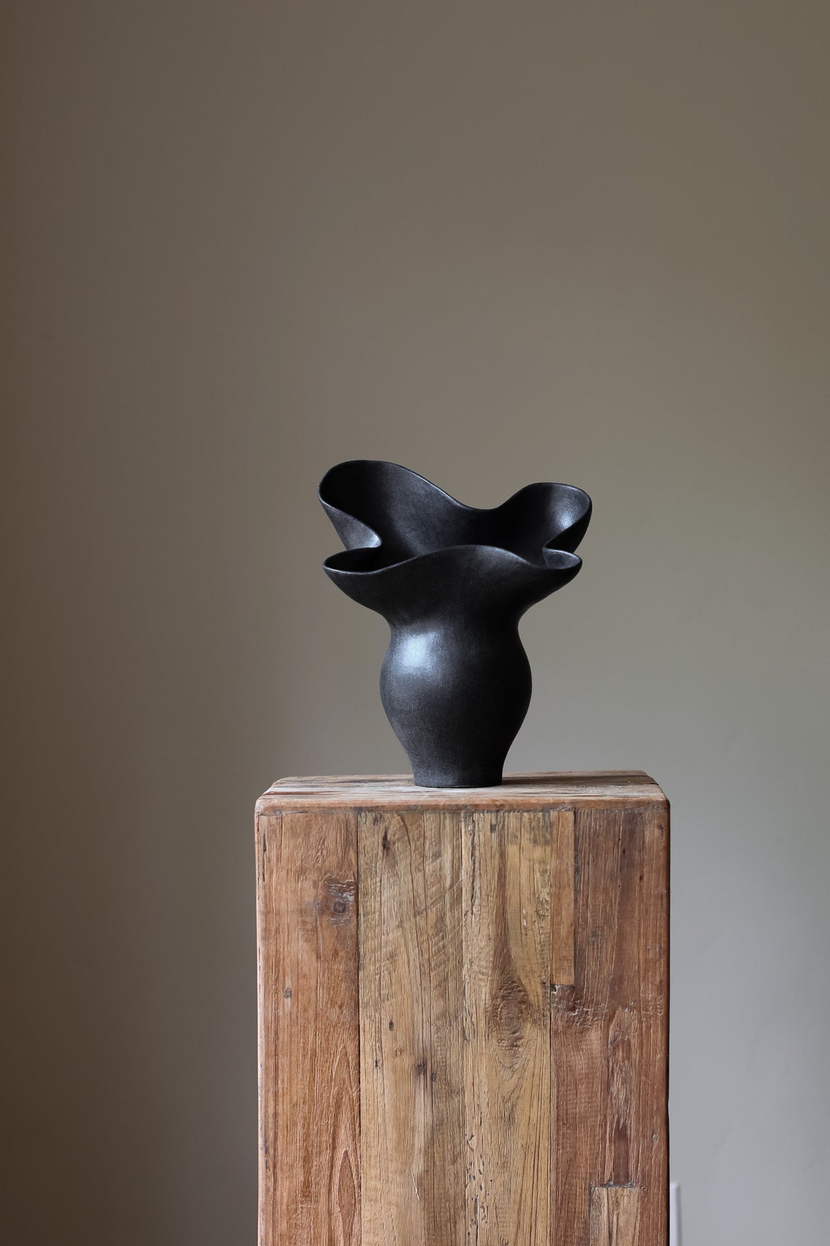 The Luna Sculptural Vessel by Karen Quirion, with sharp angles and a muted ink color, blending brutalist design with delicate, lyrical elements. A perfect statement piece for modern decor.