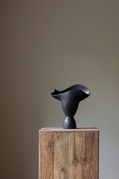 Adorned Sculptural Vessel INK by Karen Quirion, showcasing angular details and a monochrome color tone. This handmade vase merges brutalist architecture with soft, poetic design, adding architectural elegance to any interior. Perfect for minimalist decor and floral displays.