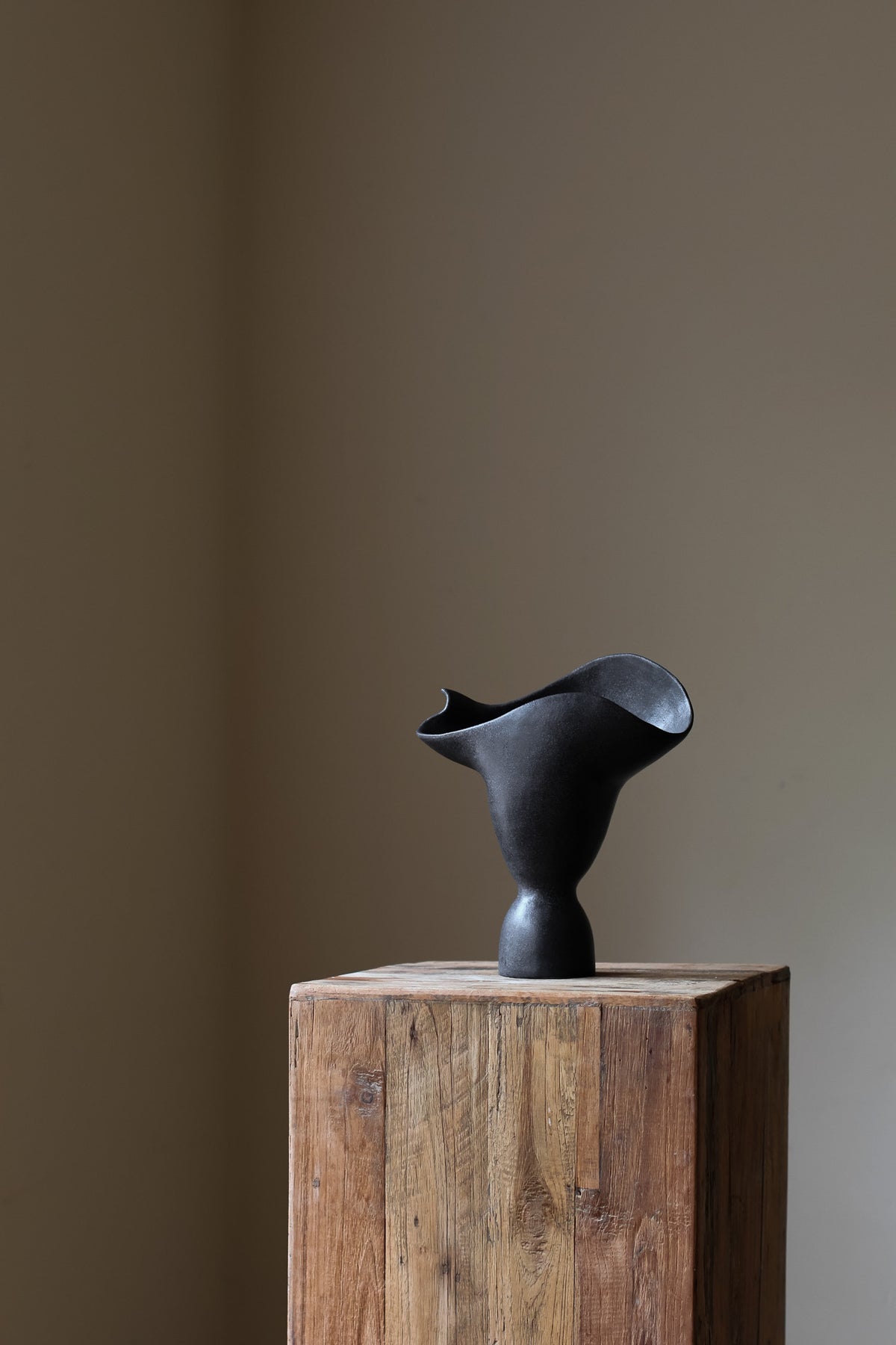 Adorned Sculptural Vessel INK by Karen Quirion, showcasing angular details and a monochrome color tone. This handmade vase merges brutalist architecture with soft, poetic design, adding architectural elegance to any interior. Perfect for minimalist decor and floral displays.