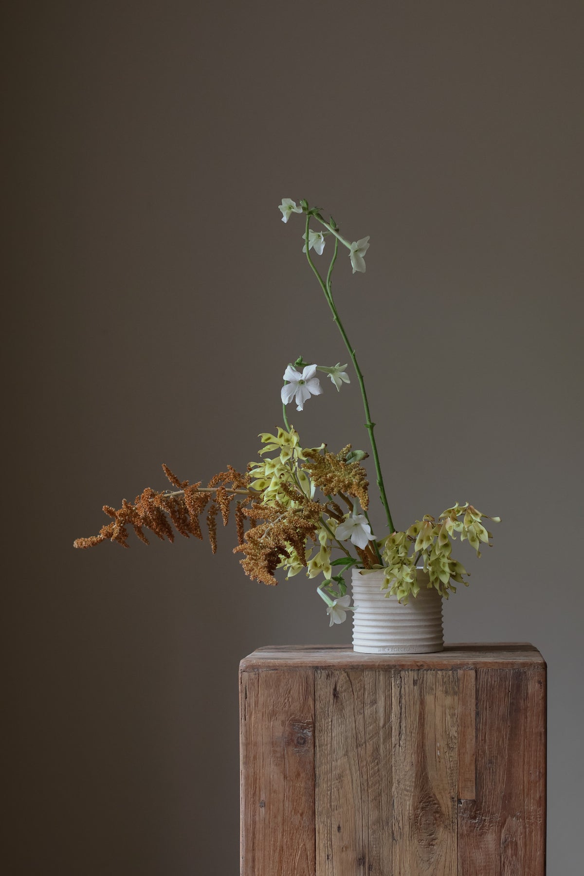 Elegant handmade lidded vessel in cream with raw texture and glazed interior, perfect for upscale interiors as a ring holder, coin keeper, or incense container.