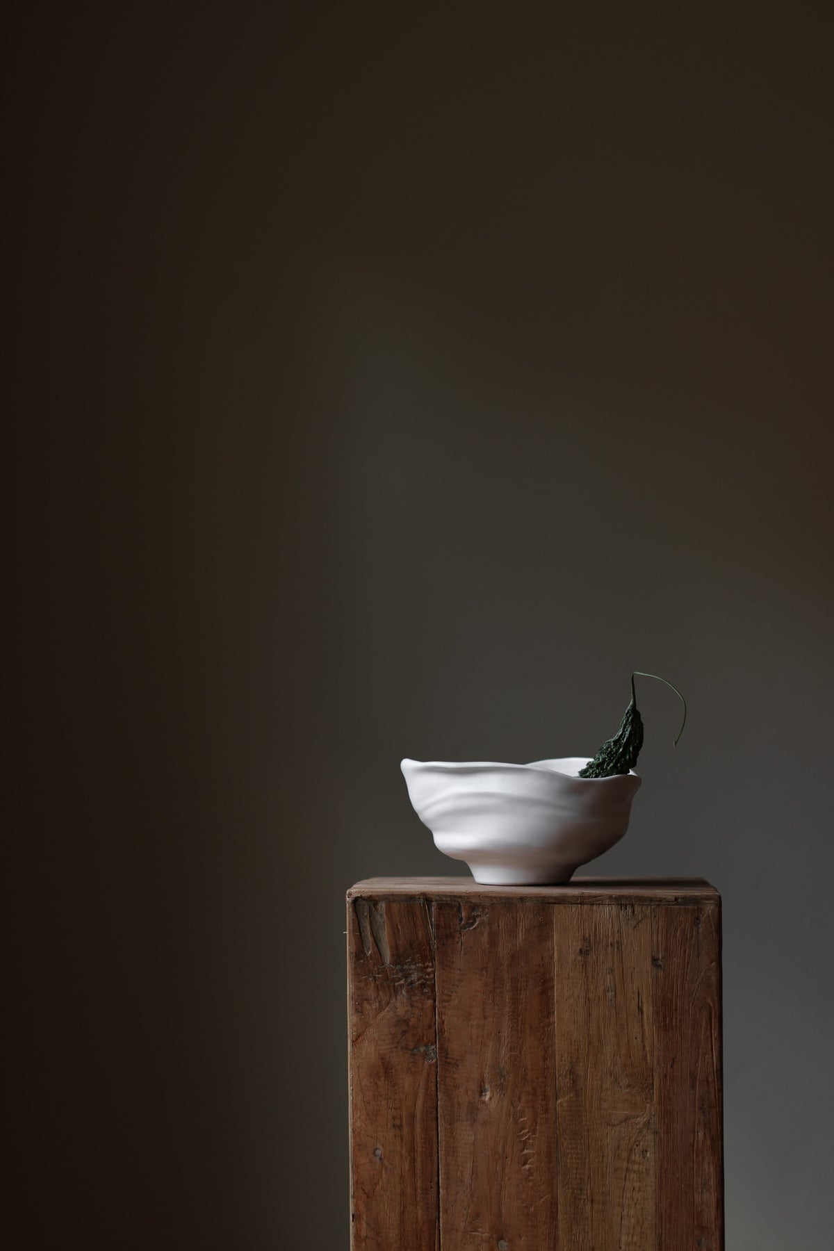 Handmade porcelain bowl with satin glaze, unique surface variations, perfect for kitchen, coffee table, or living room styling.