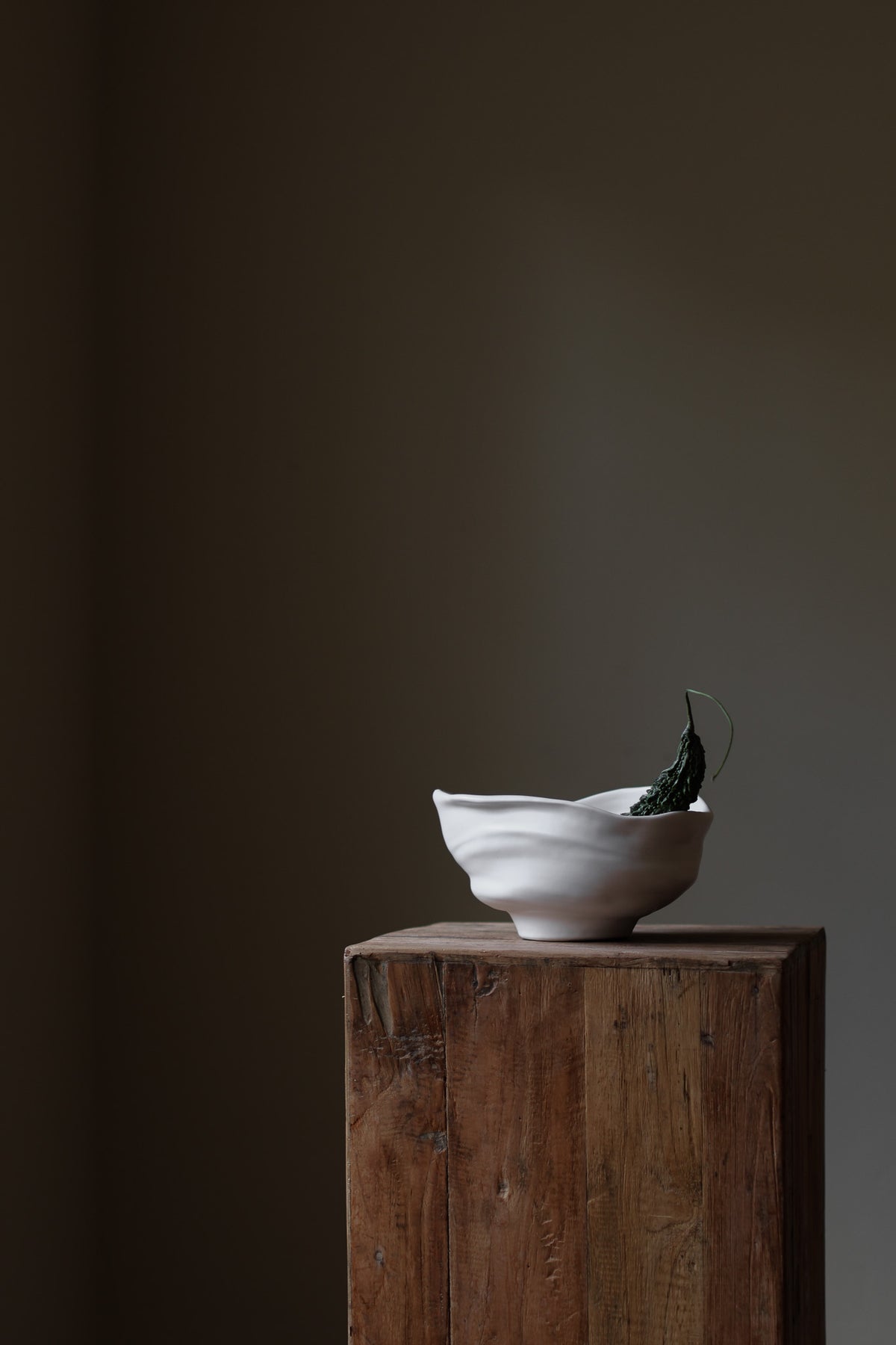 Handmade porcelain bowl with satin glaze, unique surface variations, perfect for kitchen, coffee table, or living room styling.