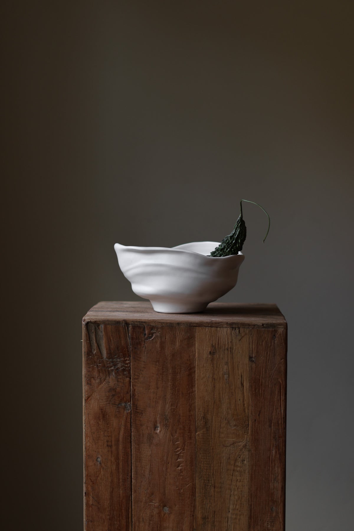 Handmade porcelain bowl with satin glaze, unique surface variations, perfect for kitchen, coffee table, or living room styling.