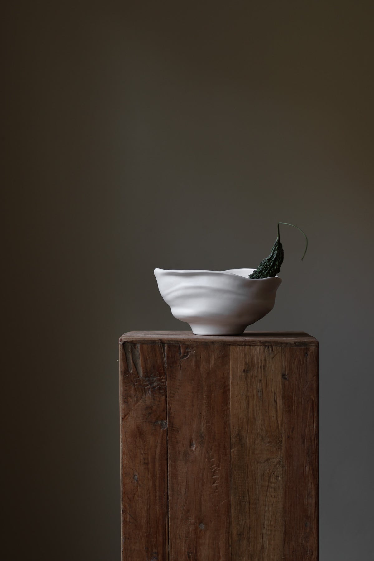 Handmade porcelain bowl with satin glaze, unique surface variations, perfect for kitchen, coffee table, or living room styling.
