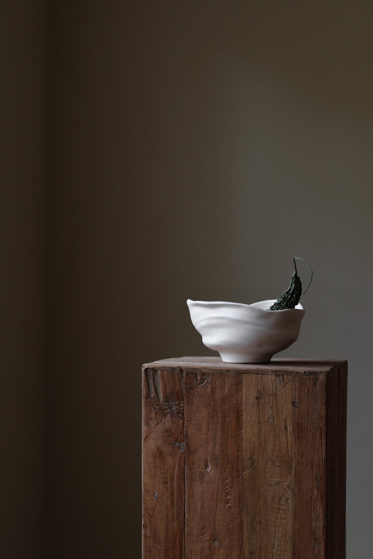 Handmade porcelain bowl with satin glaze, unique surface variations, perfect for kitchen, coffee table, or living room styling.