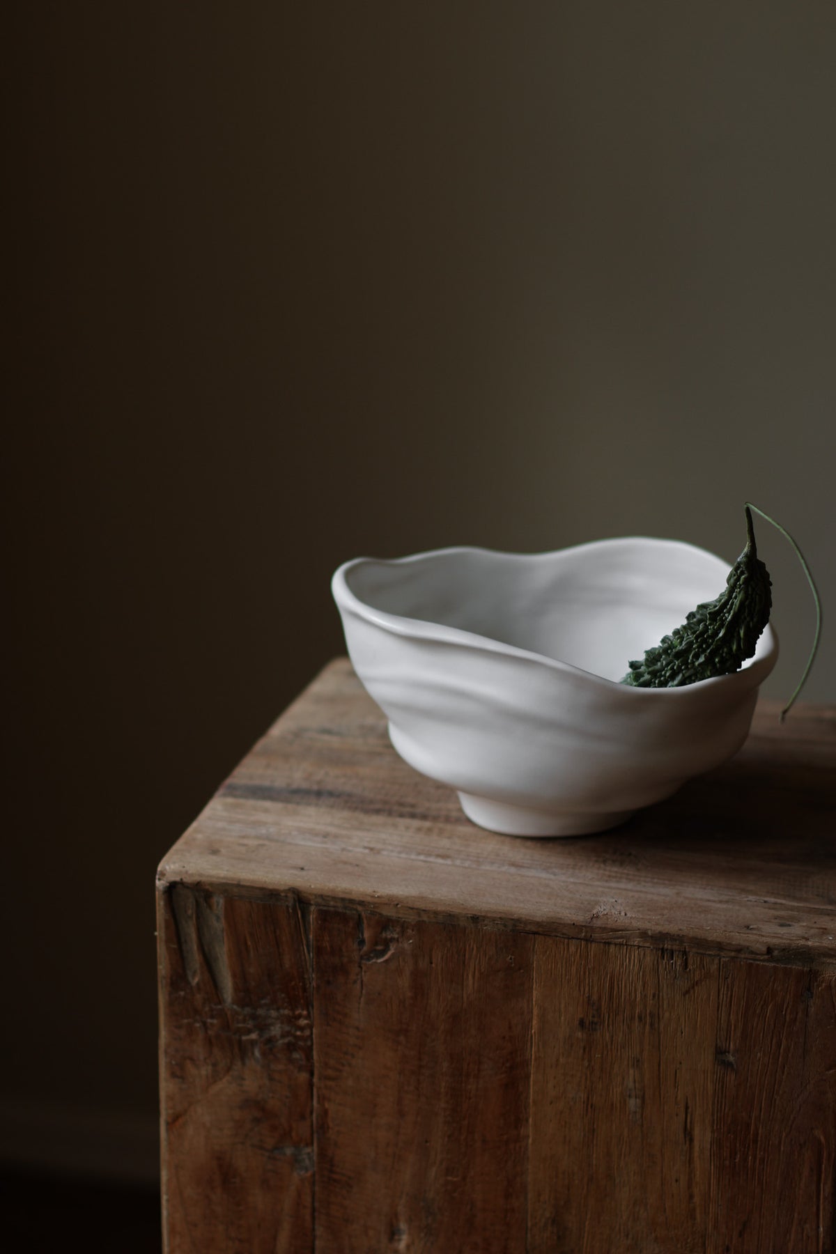 Handmade porcelain bowl with satin glaze, unique surface variations, perfect for kitchen, coffee table, or living room styling.